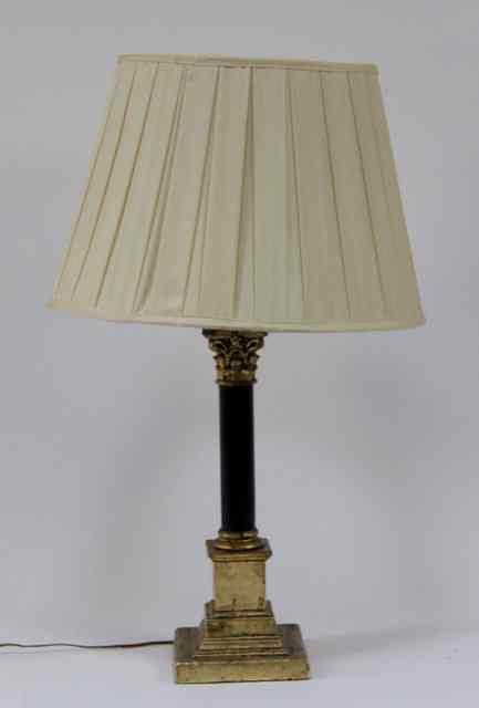 Appraisal: A table light with ebonised pillar and Corinthian capital on