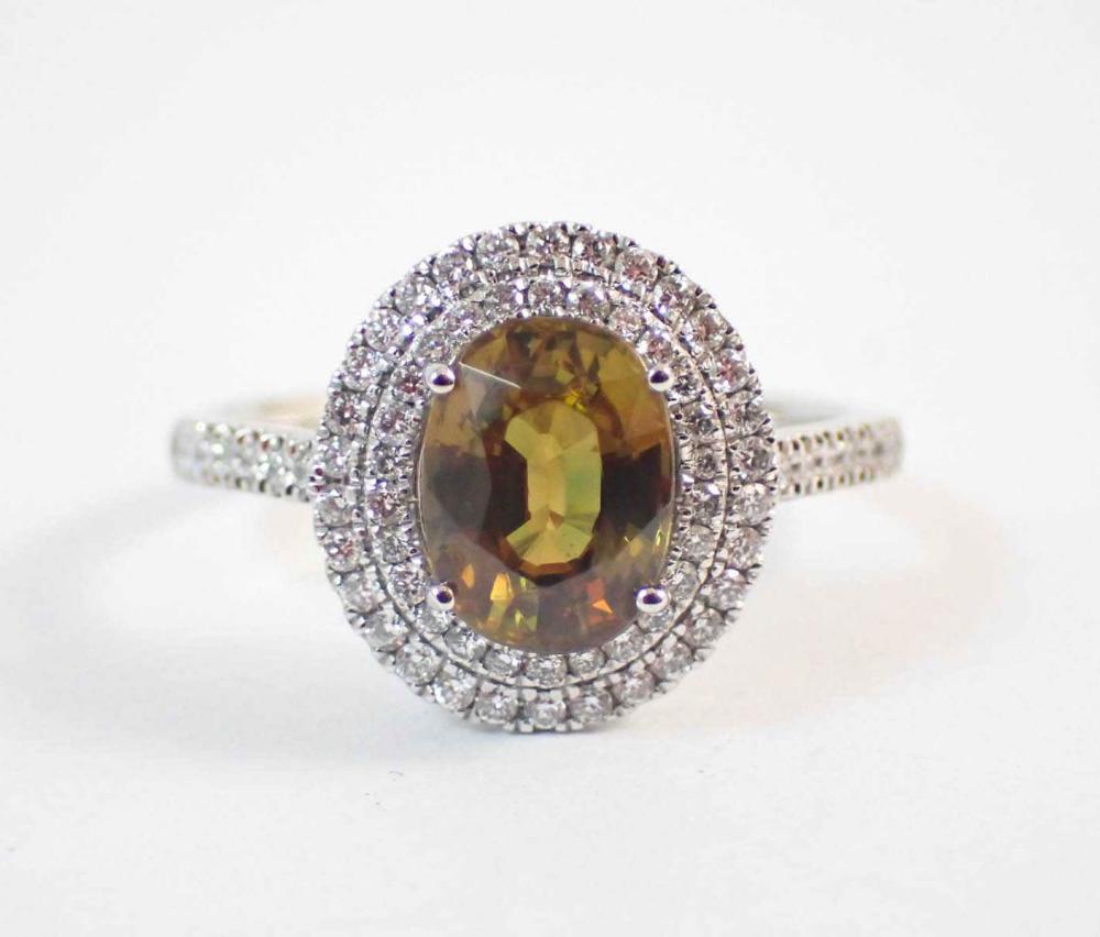 Appraisal: SPHENE TITANITE DIAMOND AND PLATINUM RING featuring an oval-cut golden