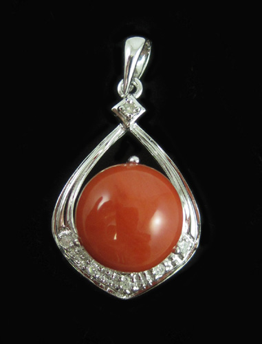 Appraisal: CORAL DIAMOND AND FOURTEEN KARAT GOLD PENDANT The white gold