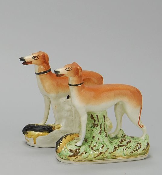 Appraisal: PAIR OF STAFFORDSHIRE FIGURES OF WHIPPETS Circa With hares lying