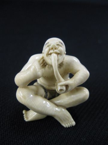 Appraisal: Carved Ivory Netsuke of a Seated Man smoking his pipe