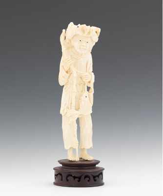 Appraisal: A Carved Ivory Statuette of a Fisherman Standing figure holding