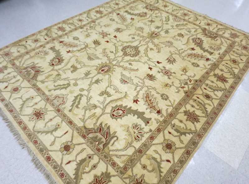 Appraisal: HAND KNOTTED ORIENTAL CARPET Indo-Persian overall floral design on khaki