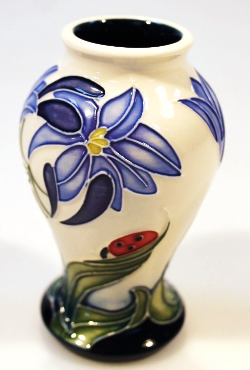 Appraisal: A Moorcroft Fly Away Home Series Cornflower and Ladybird pattern