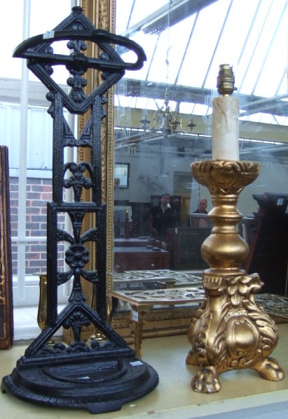 Appraisal: A cast iron umbrella stand a pair of brass candlesticks