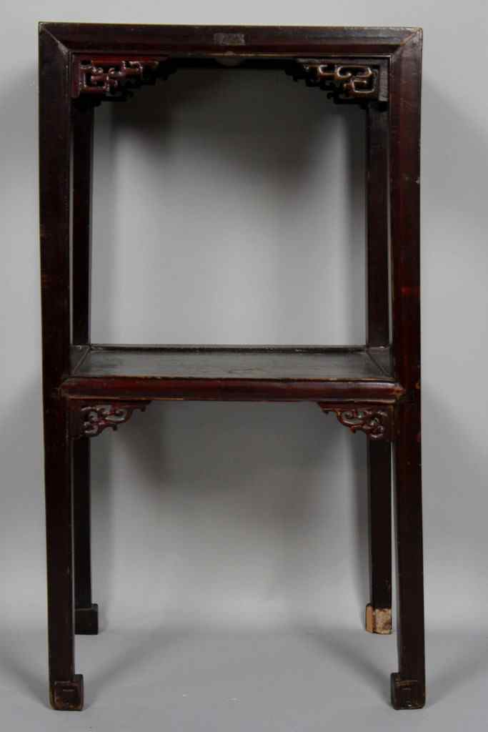 Appraisal: CHINESE HARDWOOD TWO-TIER TABLE The square top with carved spandrels