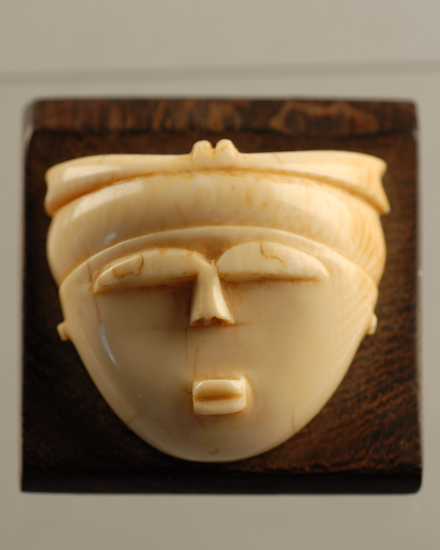 Appraisal: An Ethnic Ivory Carving of a Face mounted on a