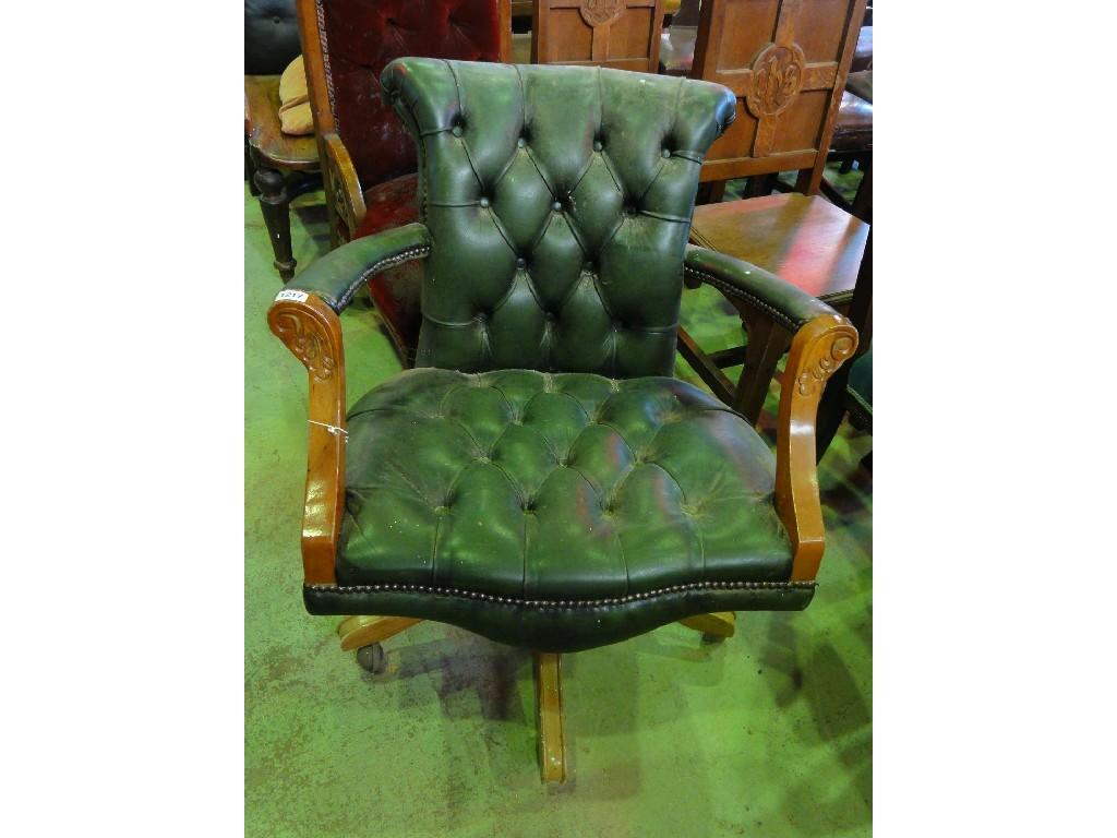 Appraisal: A swivel office elbow chair with green leather button seat