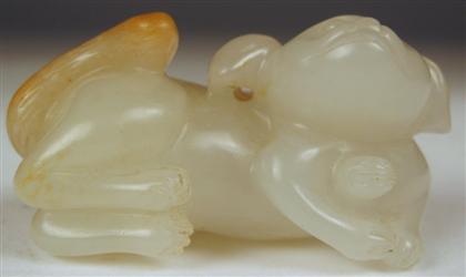 Appraisal: Chinese white jade houndThe small carving depicts a recumbent hound