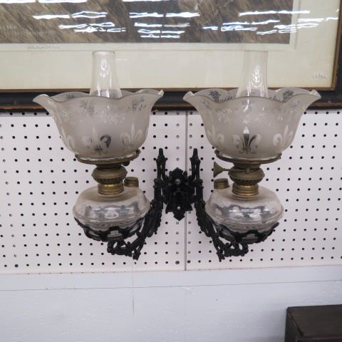 Appraisal: Victorian Wall Mounted Oil Lamps iron bracket acid etched shades