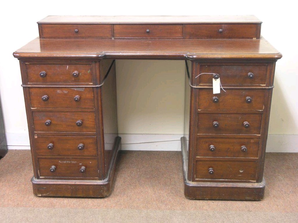 Appraisal: A Victorian mahogany kneehole writing desk the top fitted with