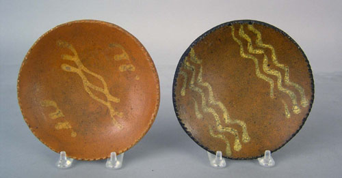 Appraisal: Two redware plates th c with yellow slip decoration dia