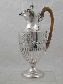 Appraisal: A silver wine ewer of half fluted design with ribbons