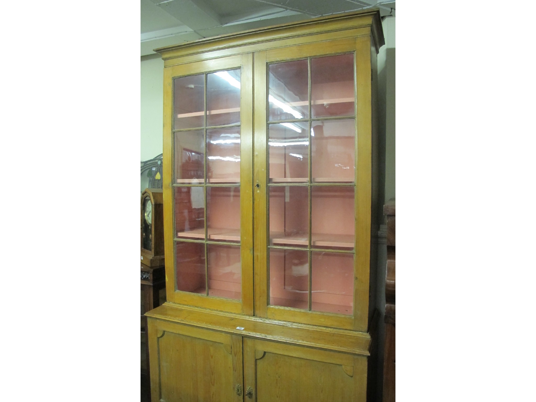 Appraisal: Late Victorian glazed pine bookcase on cupboard base