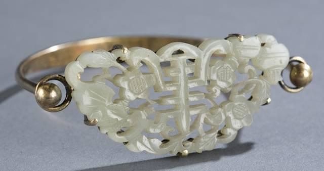 Appraisal: Chinese carved white jade mounted on a bracelet A Chinese