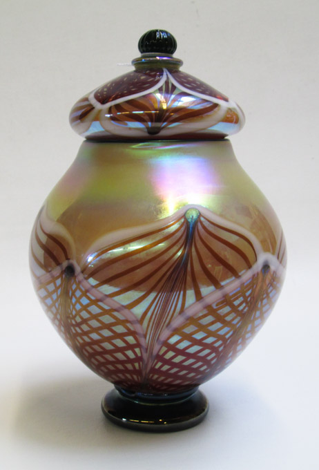 Appraisal: RICK STRINI IRIDESCENT ART GLASS LIDDED JAR Florentine design engraved