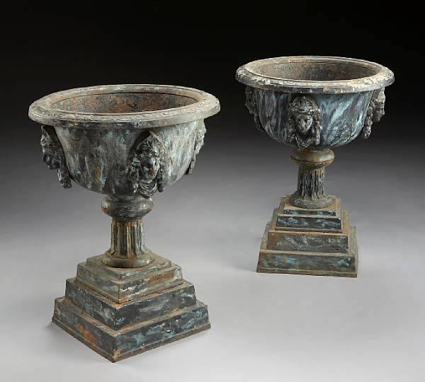 Appraisal: A pair of Victorian painted cast iron urns last quarter