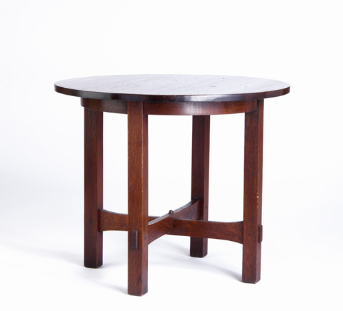 Appraisal: GUSTAV STICKLEY Lamp table with trumpeted cross-stretchers and a circular