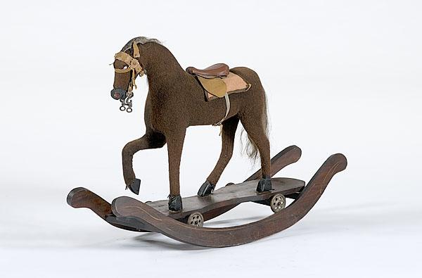 Appraisal: ROCKING PULL TOY HORSE th century A hide-covered pull toy