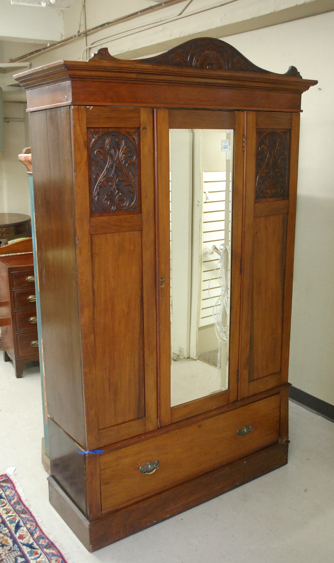 Appraisal: LATE VICTORIAN WALNUT WARDROBE English c with mirror-paneled single door