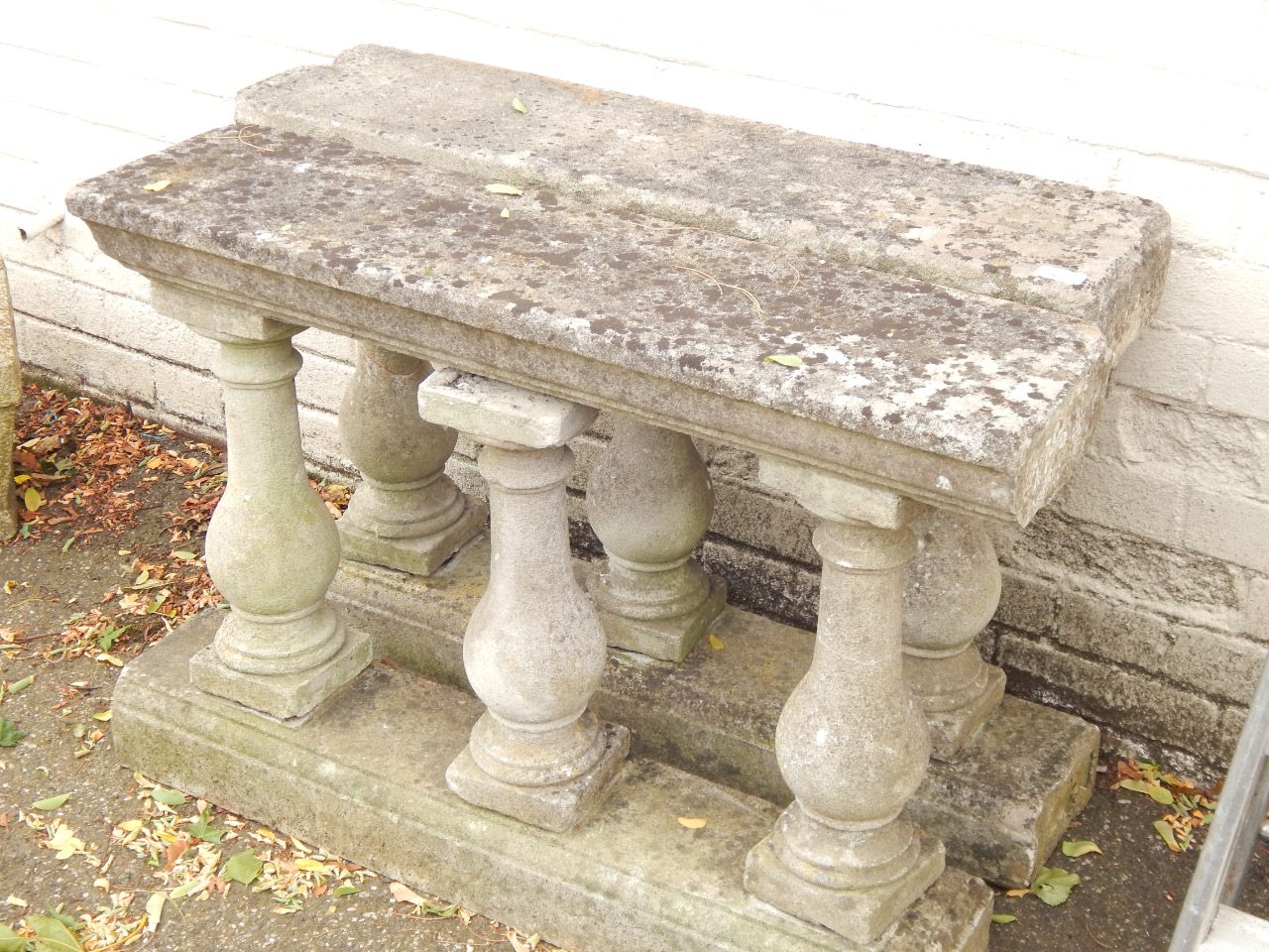 Appraisal: Two sections of stone balustrade each having a platform top