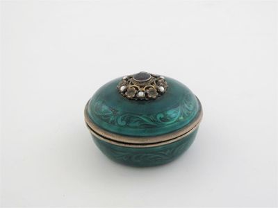 Appraisal: A continental silvergilt and emerald green-enamelled dressing table box and