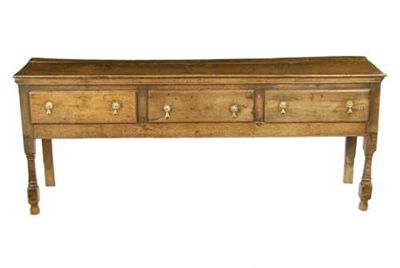 Appraisal: An oak dresser the planked top above three drawers and