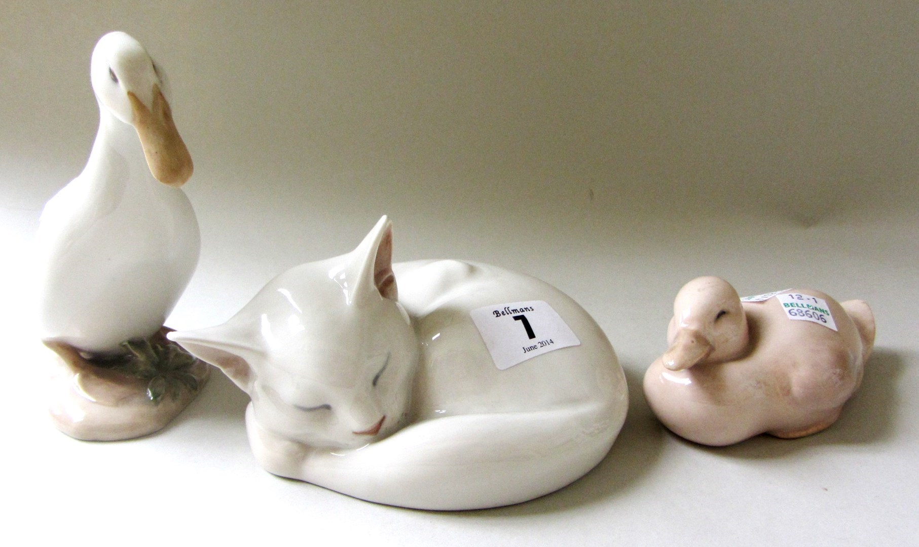 Appraisal: Three Royal Copenhagen porcelain animals a white cat No a