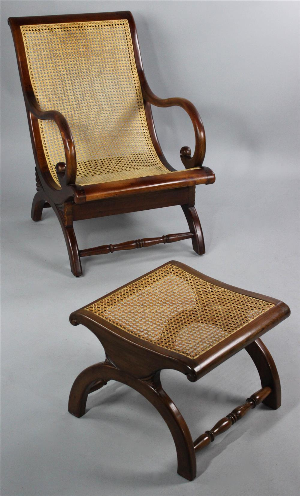 Appraisal: ANGLO-INDIAN STYLE HARDWOOD CANED ARMCHAIR AND OTTOMAN having a rolled