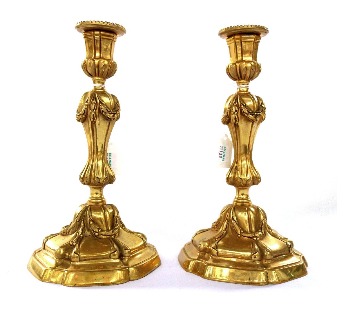 Appraisal: A pair of Georgian style gilt bronze candlesticks modern with