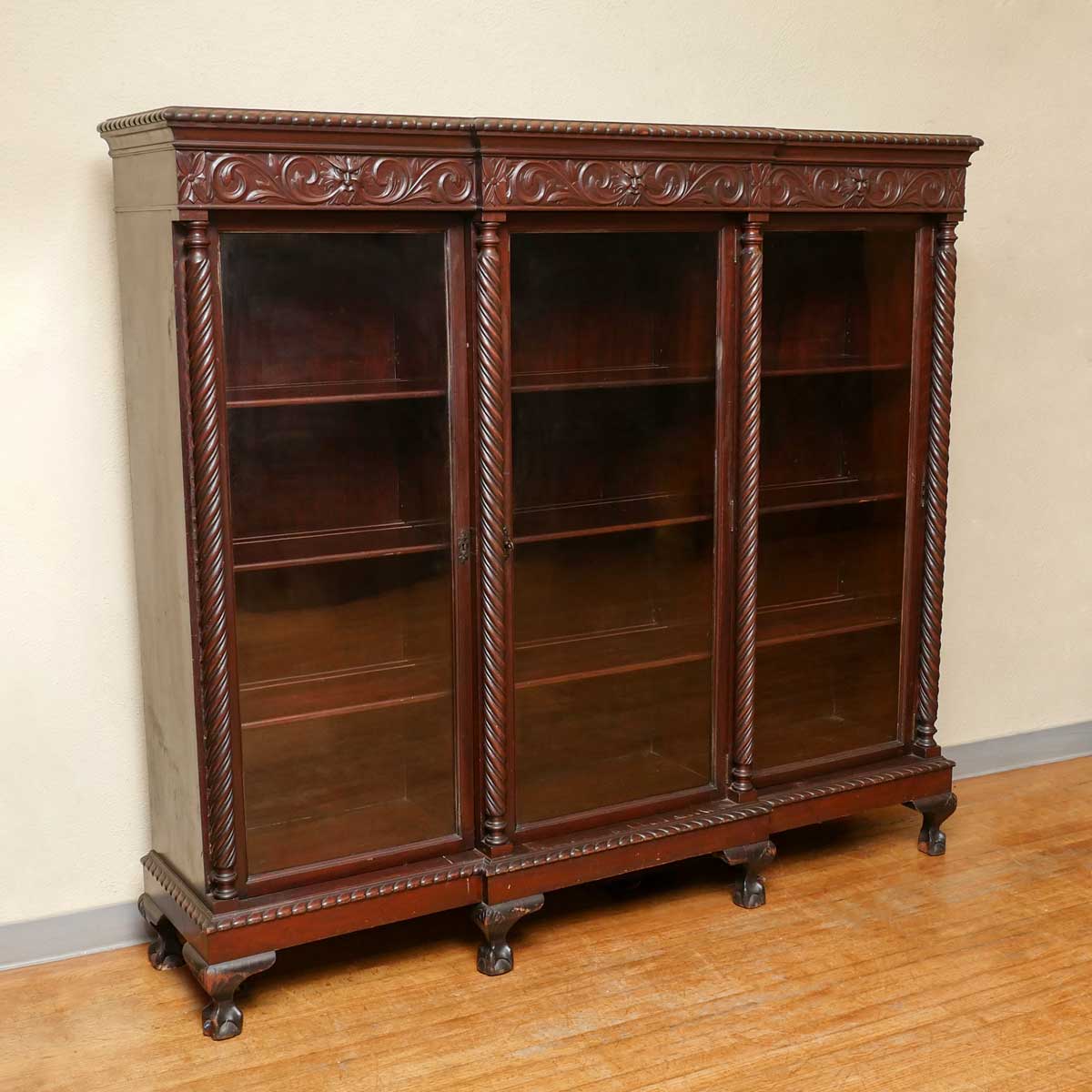 Appraisal: MAHOGANY HORNER QUALITY CARVED BOOKCASE Glass doors reveal shelved interiors