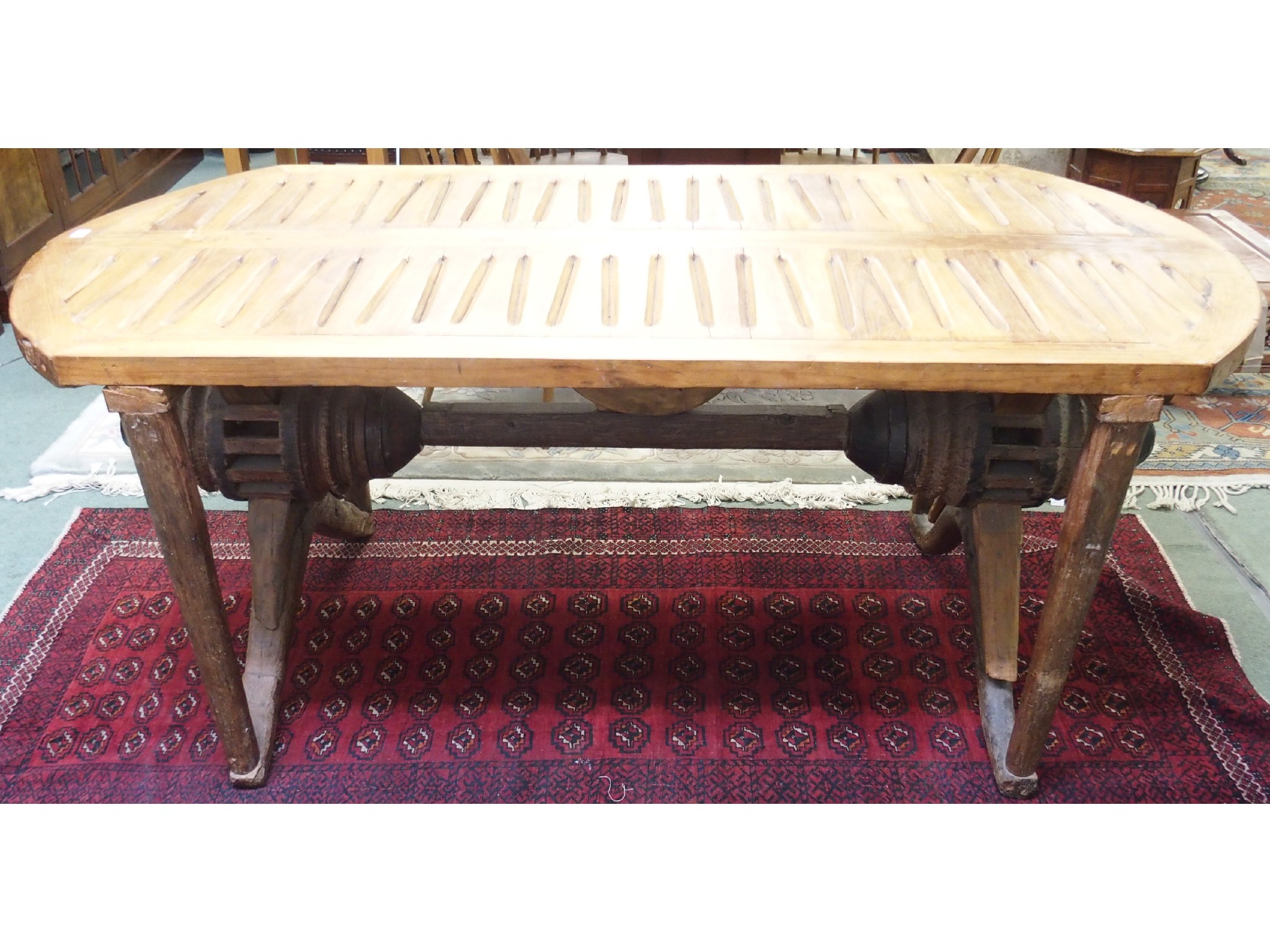 Appraisal: A teak topped D-end garden table supported by a set