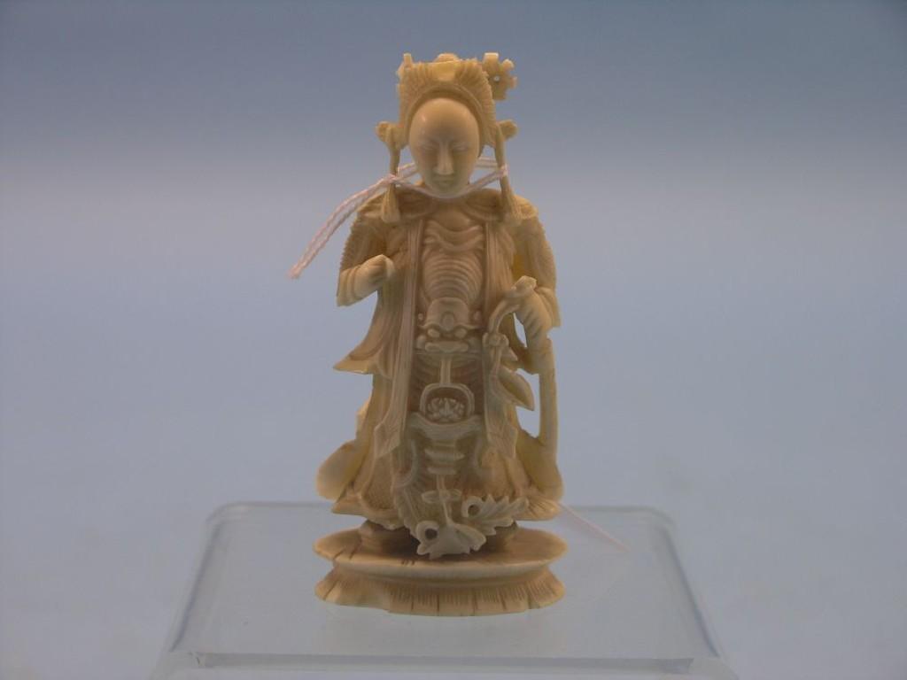 Appraisal: A Chinese carved ivory figure female standing on lotus base