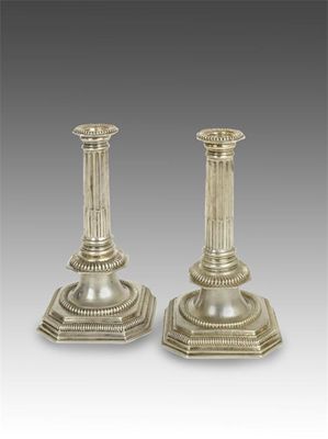 Appraisal: A pair of William III candlesticks with fluted columns canted