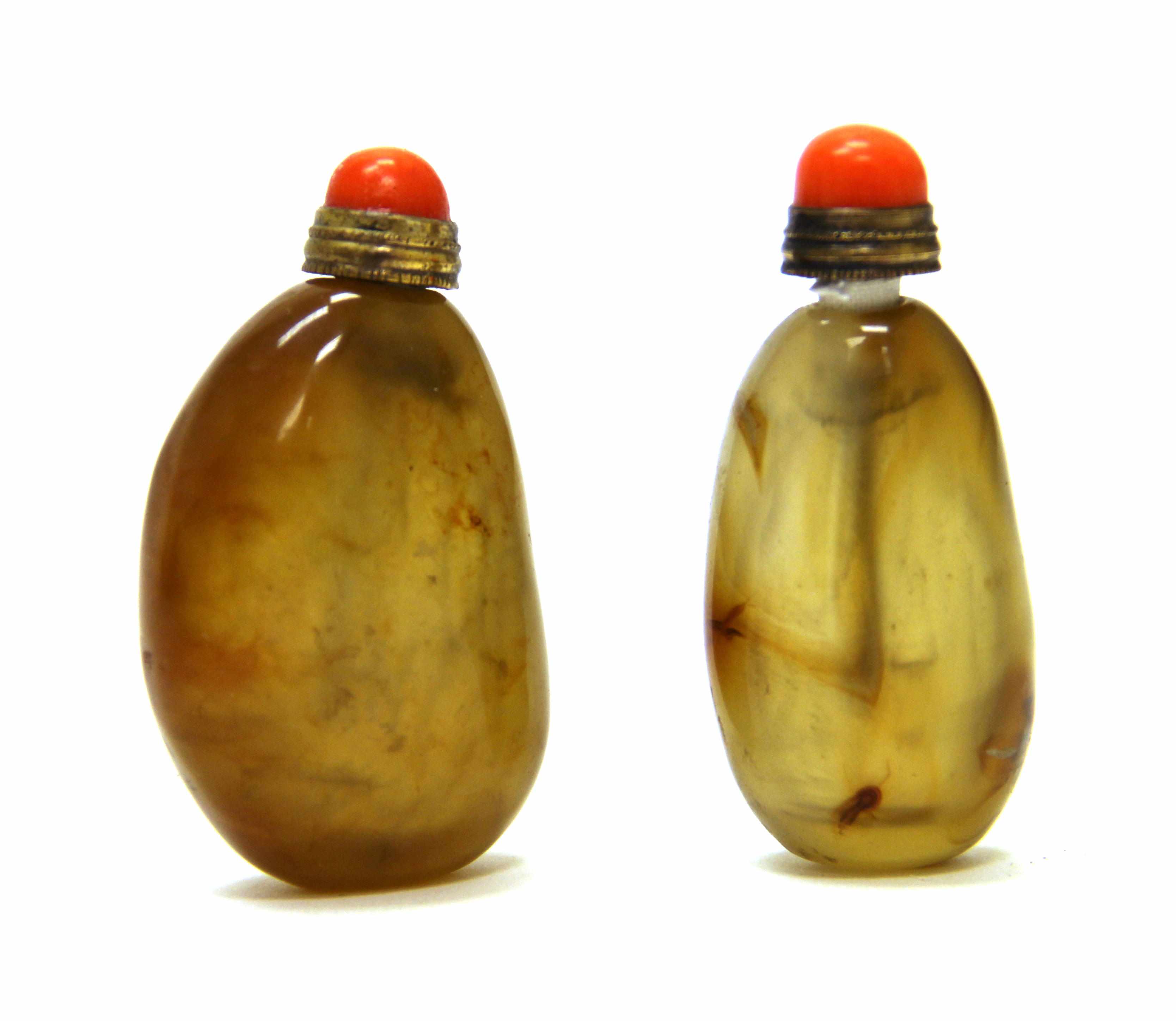 Appraisal: Two pebble-form agate snuff bottles The larger bottle fairly well