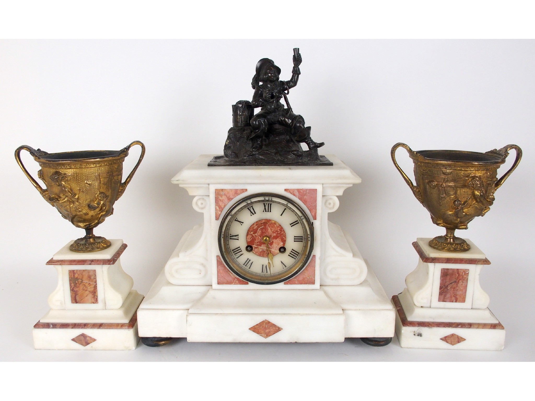 Appraisal: A white marble clock garniturewith bronze cavalier seated drinking above