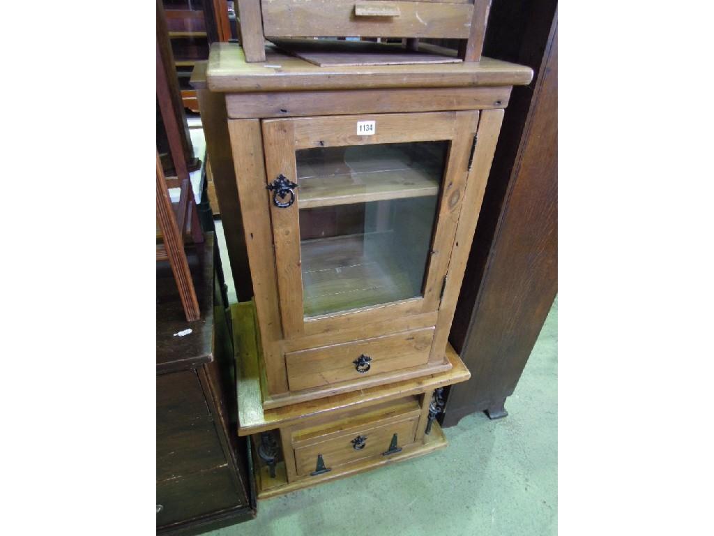 Appraisal: A stripped pine side cabinet enclosed by a glazed panelled