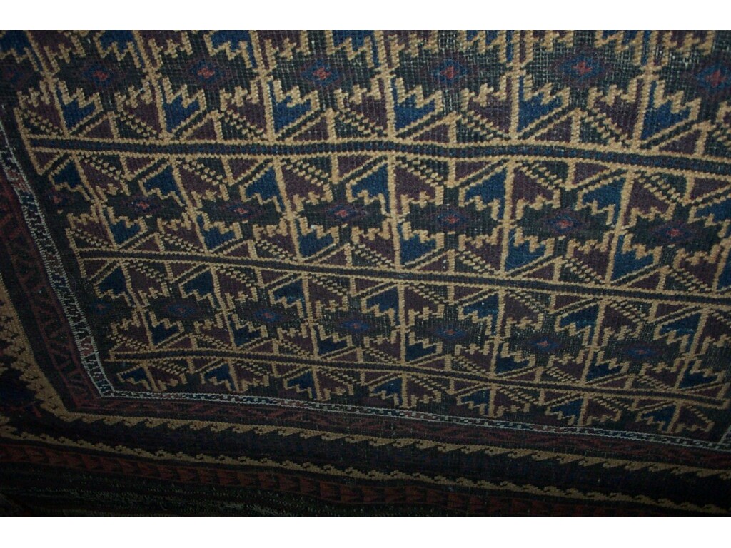 Appraisal: An Eastern wool rug with hooked and geometric decoration in