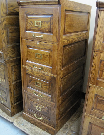 Appraisal: FOUR-DRAWER OAK FILE CABINET American antique reproduction featuring a column