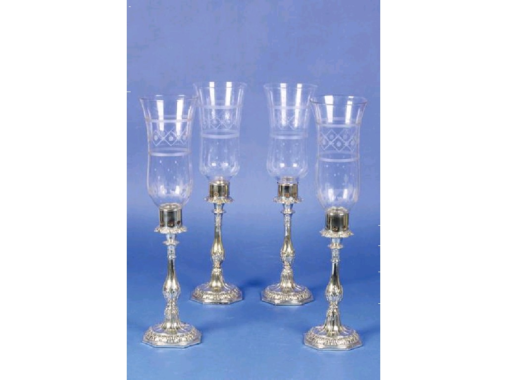 Appraisal: A SET OF FOUR LATE VICTORIAN CANDLESTICKS converted to hurricane