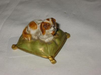 Appraisal: A ROYAL WORCESTER PORCELAIN SPANIEL modelled recumbent on a green