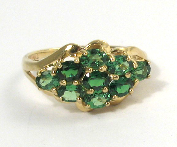 Appraisal: TSAVORITE GARNET AND YELLOW GOLD CLUSTER RING The k yellow