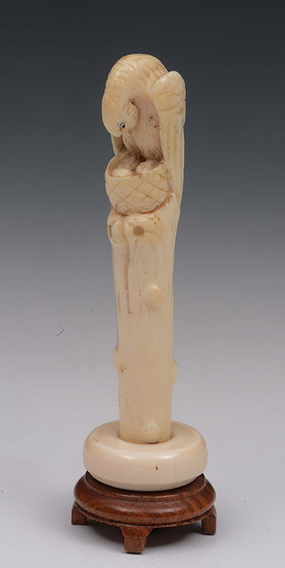 Appraisal: A carved ivory parasol handle in the form of an