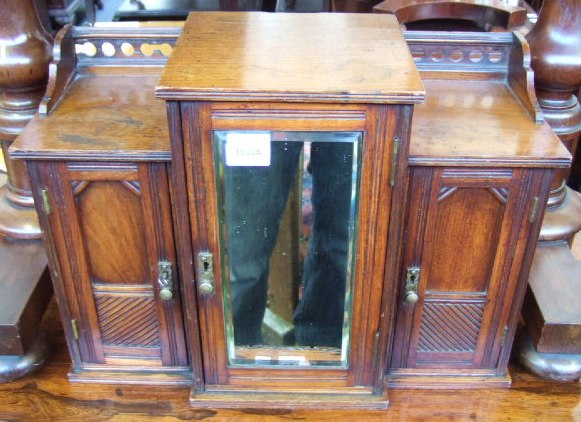 Appraisal: A late Victorian oak table cabinet in the form of