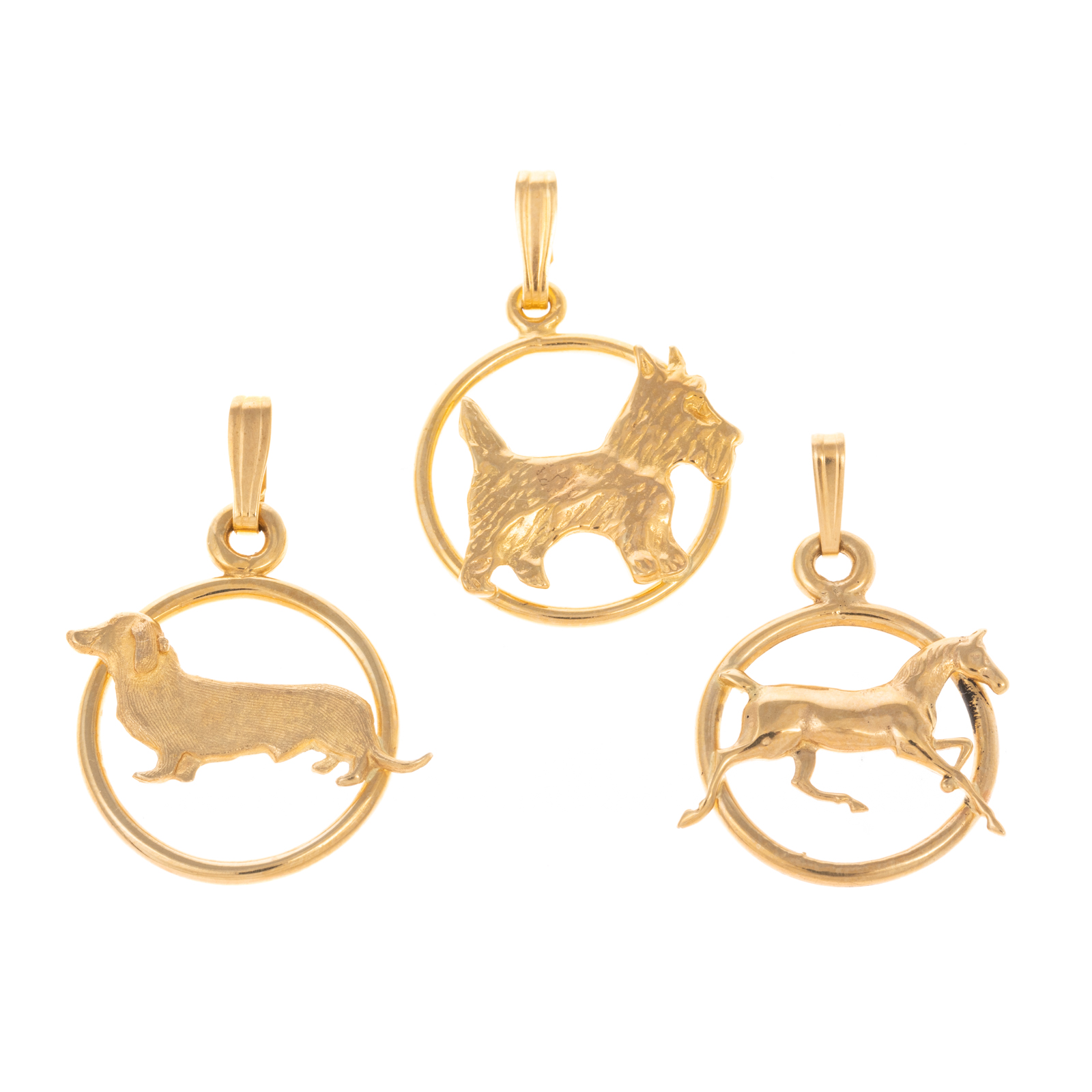 Appraisal: A TRIO OF ANIMAL DISC CHARMS IN K K yellow