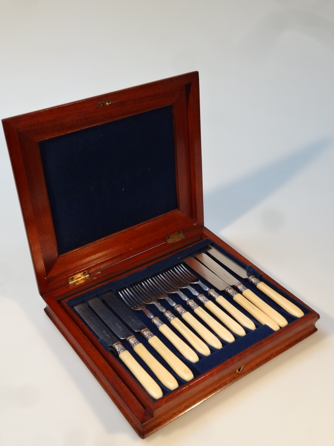 Appraisal: An Edwardian bone and silver plated cutlery service comprising knives