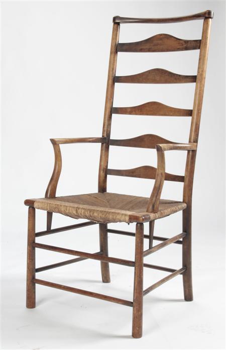 Appraisal: AFTER ERNEST GIMSON LADDER BACK ARMCHAIR CIRCA stained beech with