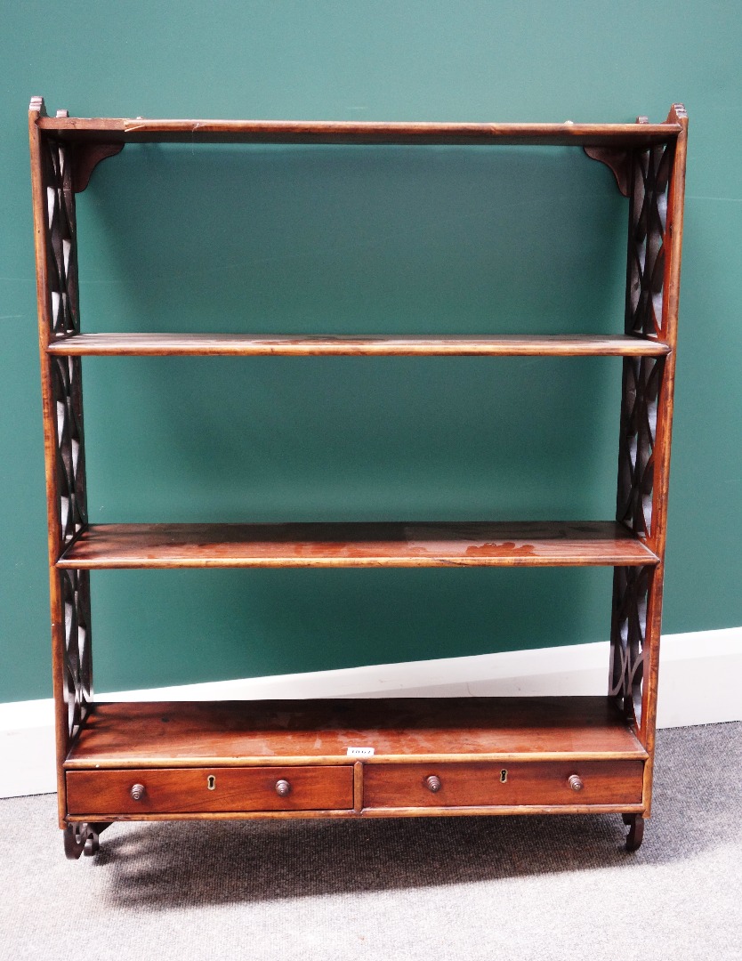 Appraisal: A George III mahogany four tier wall shelf with pierced