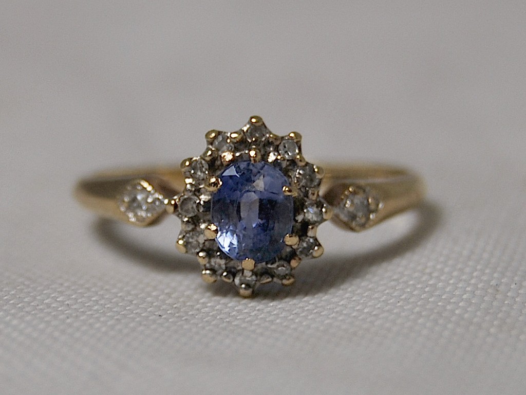 Appraisal: A ct gold ring set with imitation sapphire and diamond