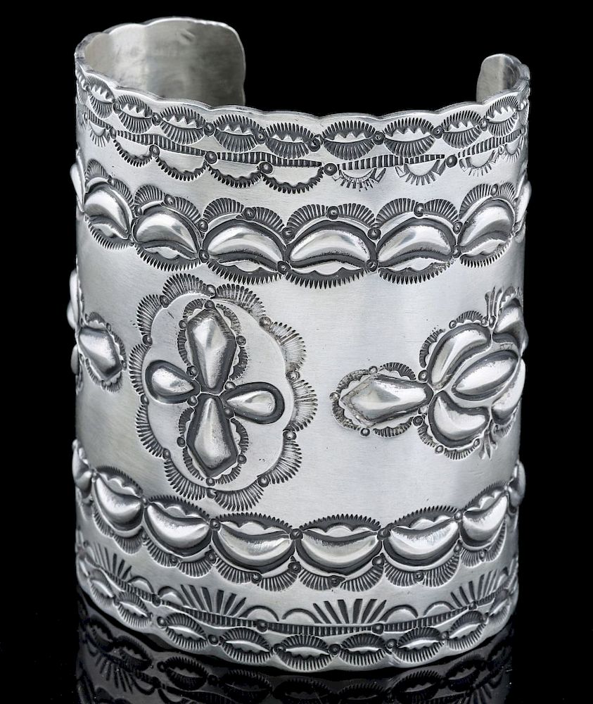 Appraisal: A WALLACE YAZZIE REPOUSSE STERLING CUFF BRACELET A very wide